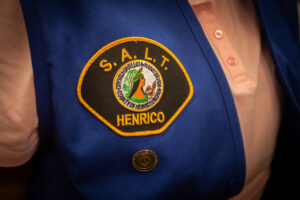 Image shows the Seniors And Law Enforcement Together Patch on a blue vest.