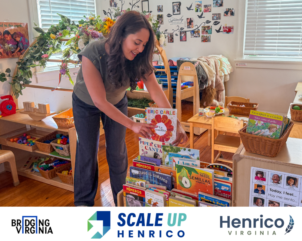 A preschool teacher shows a book in a classroom. The book by Eric Carle is in Spanish and titled La Semillita (The Tiny Seed).