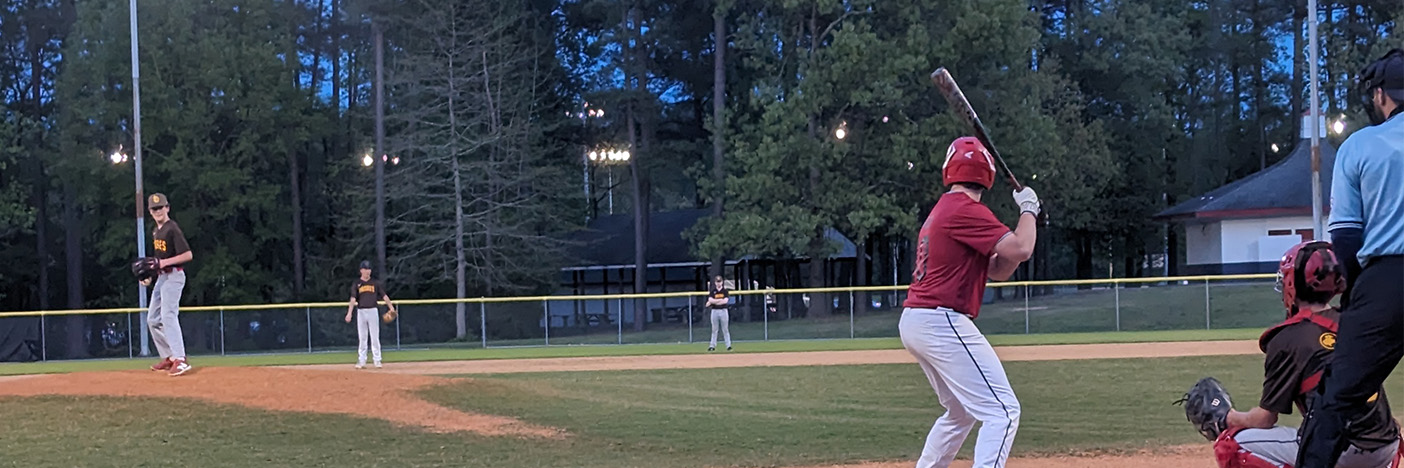 Evening game with pitcher and batter
