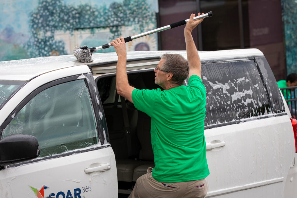 Volunteer washing a car