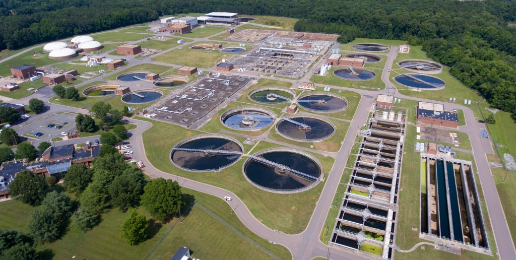 Aerial view of the Water Reclamation Facility, showing multiple buildings and pools of water in various stages of treatment.