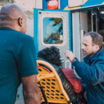 A photo of emergency responders with a patient on a stretcher.