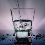 clear glass cup with water pouring in