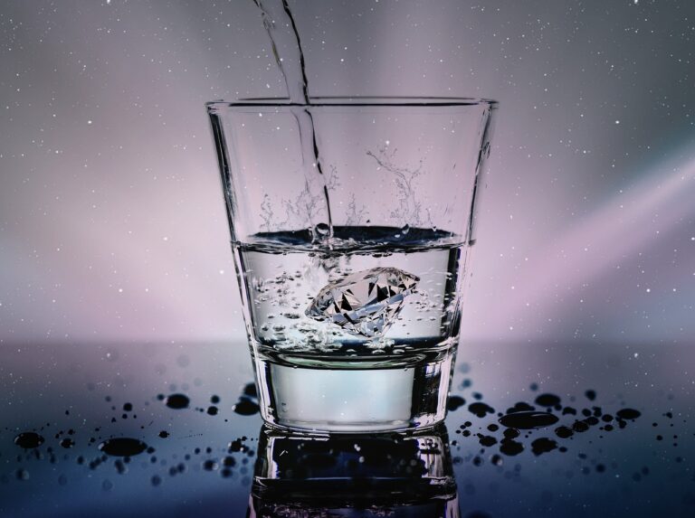 clear glass cup with water pouring in