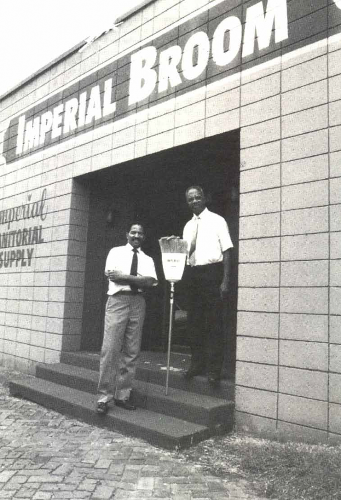 Photo of Matthew James Robinson,Sr. and a man standing in the opening of Imperial Broom 