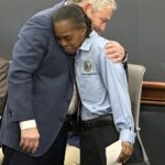 Julie Smith appears emotional as John Vithoulkas embraces her after handing her her spot bonus.