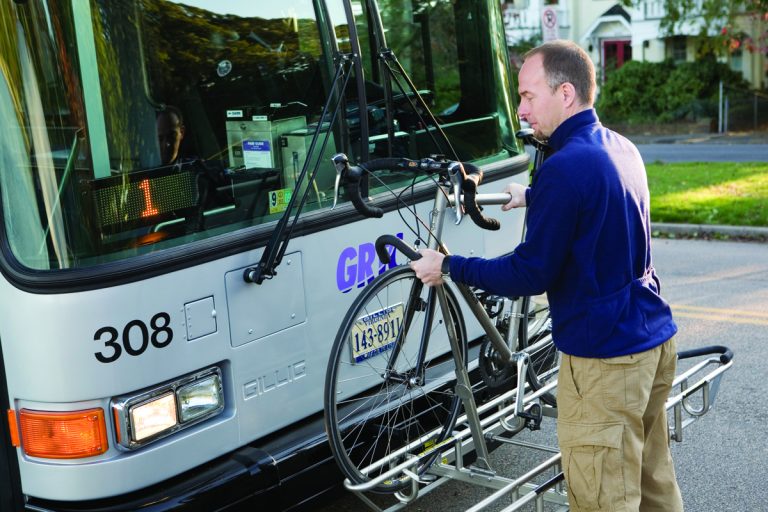 GRTC transit rider loading their bike on the front of a GRTC bus