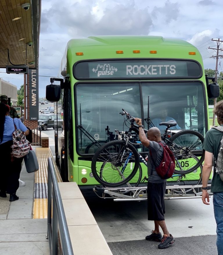 Transit rider loading their bike on to the front of a GRTC bus