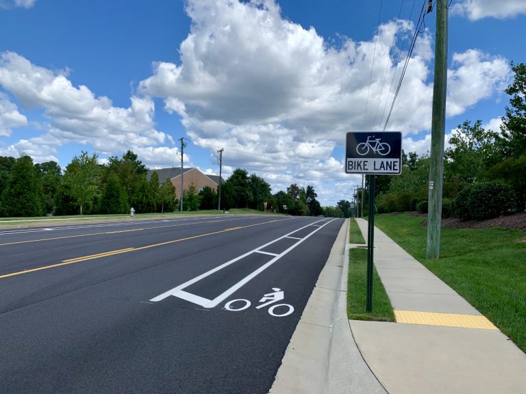 Twin hickory buffered bike lane with sign